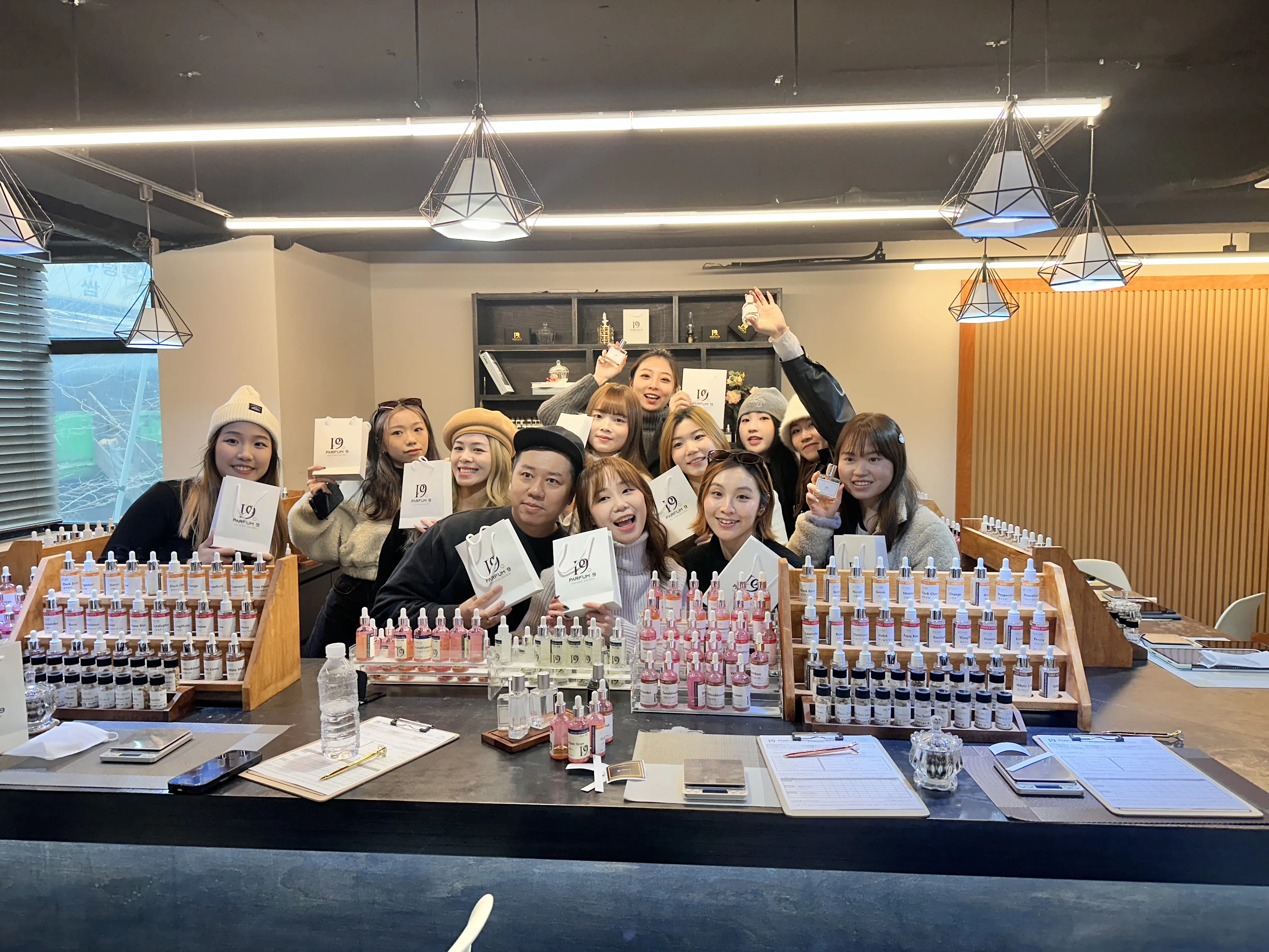 Group holding their finished custom perfumes at Parfum9