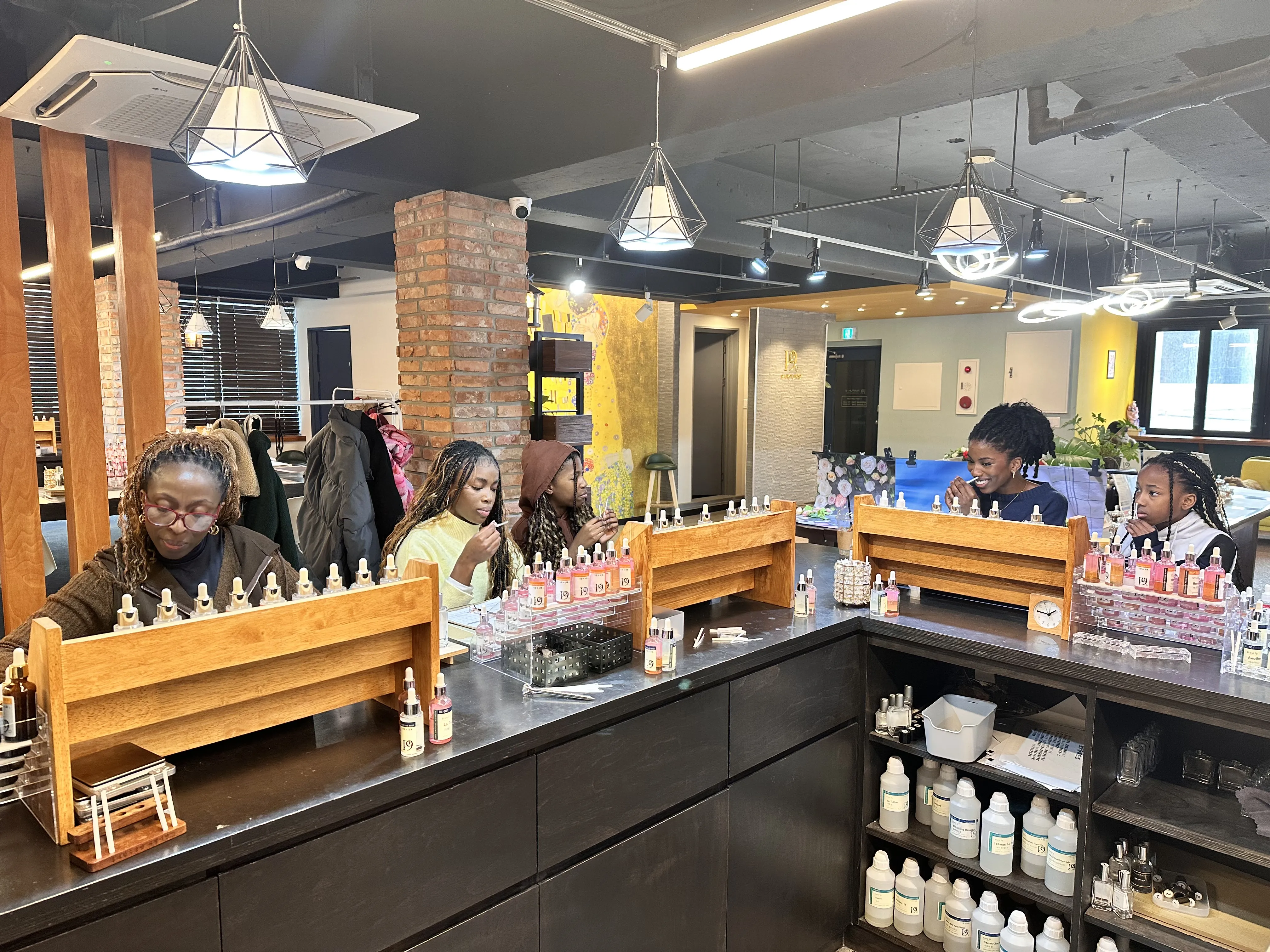 Family smelling fragrance notes during a perfume workshop