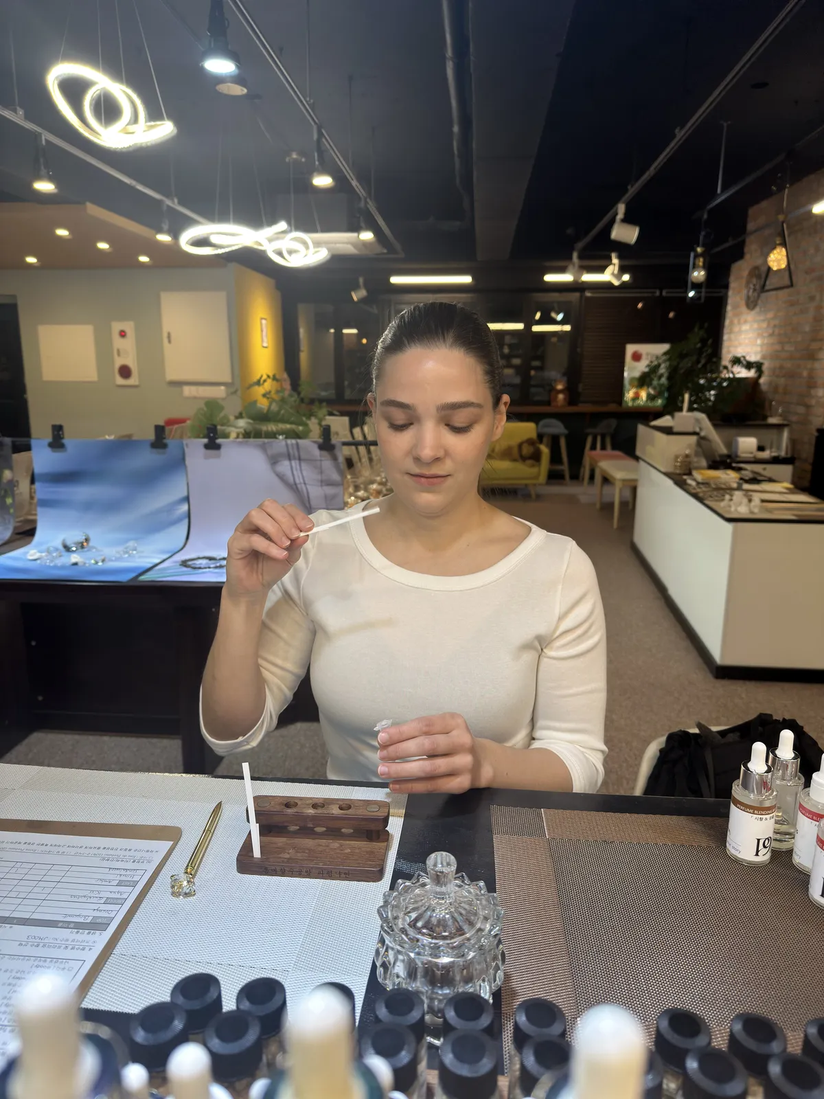 Customer smelling a scent strip during a perfume-making experience